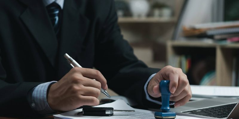 businessman-signing-a-contract-for-buying-of-selling-a-car-car-rental-service-insurance-and-contra.jpg